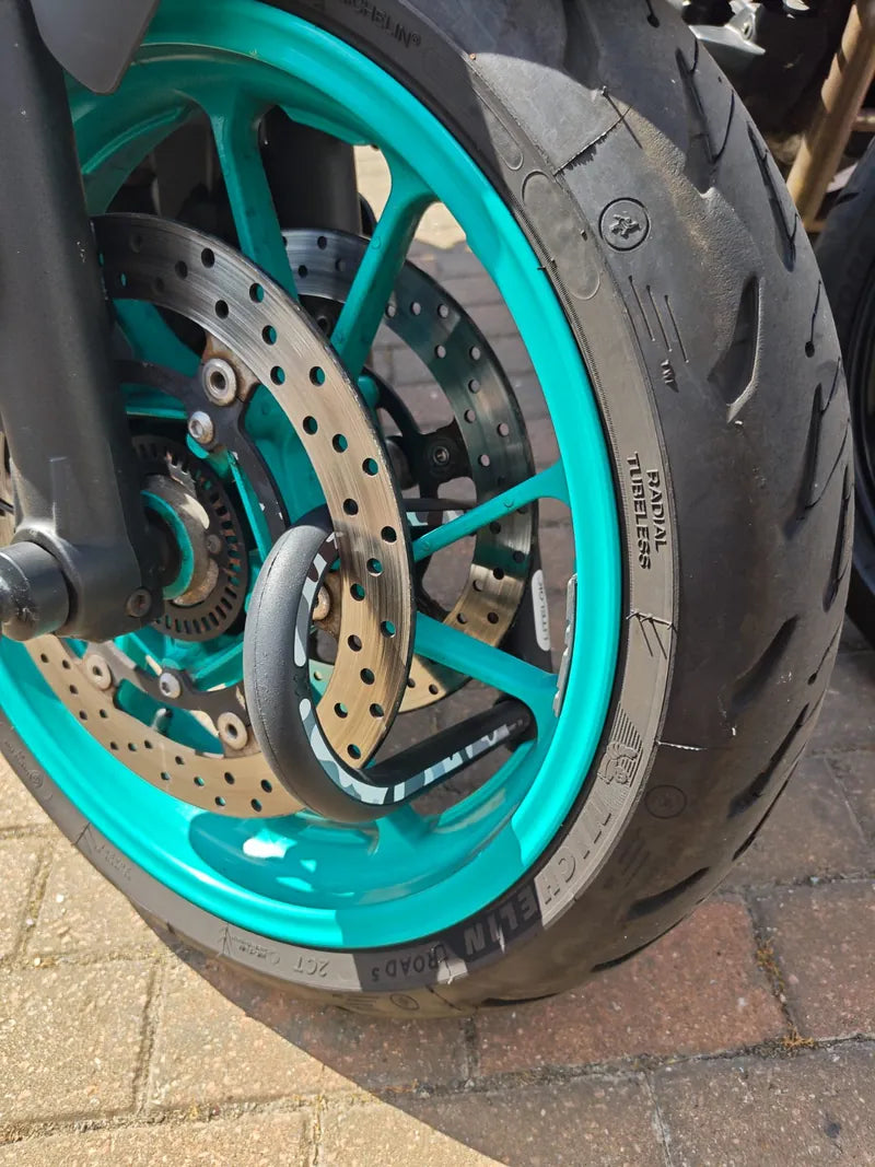 X1 Moto through the front wheel and brake disc of a Yamaha MT-07