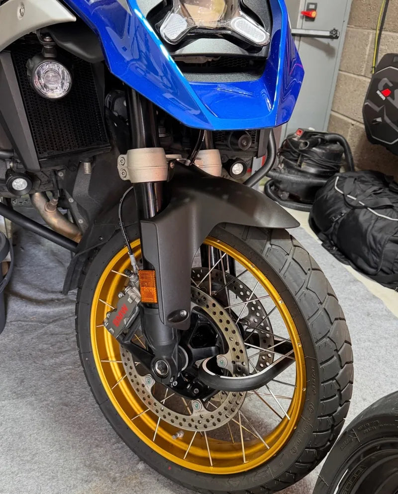 X1 Moto through the hub and spokes of a BMW R1300 GS front wheel